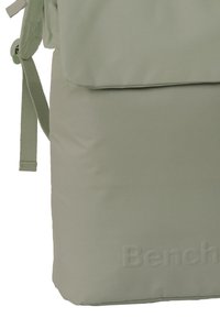 Groene rugzak met een zachte textuur en rechthoekige vorm. De merknaam "Bench" is in een bijpassende kleur op de voorkant gedrukt.