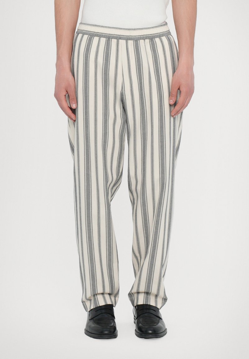 Striped trousers with a relaxed fit, featuring vertical gray and white stripes, an elastic waistband, and a soft, lightweight fabric.