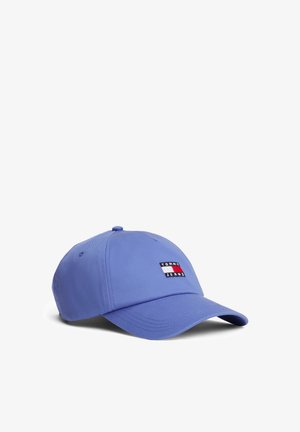 Gorra de béisbol azul clara hecha de tela, con un pequeño parche rectangular con franjas rojas, blancas y azules etiquetado "TOMMY JEANS."