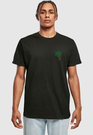 Black cotton t-shirt with short sleeves, featuring a small green palm tree graphic and brown trunk on the left chest area.