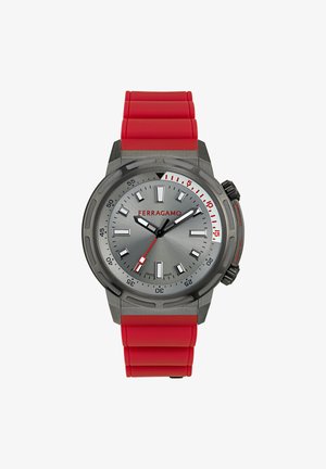 Ferragamo watch with a silver-gray dial, red accents, and a red rubber strap. Features large hour markers, rotating bezel, and a textured case.