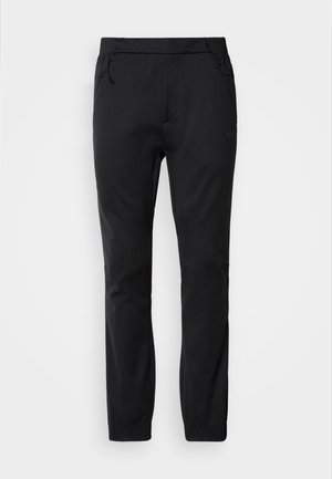 Pantaloni de jogging negri cu talie elastică, buzunare laterale cu fermoar, picioare conice și material texturat cu detalii subtile ale modelului.