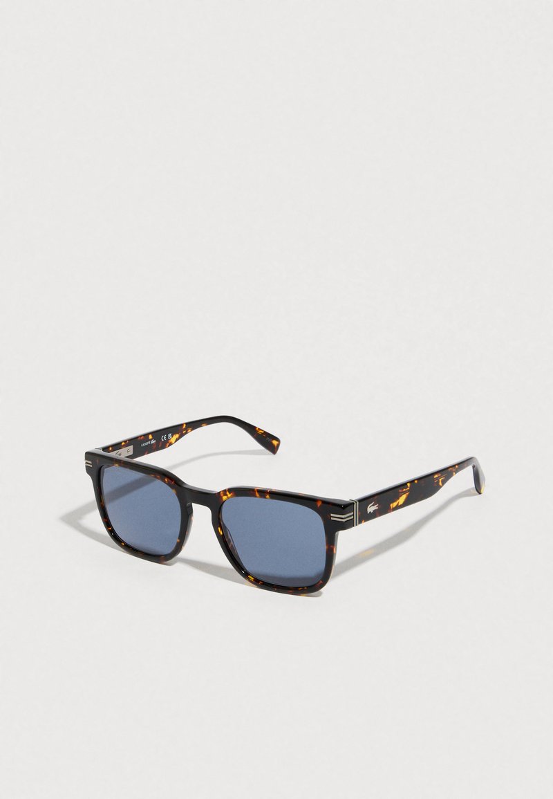 Square blue-lensed sunglasses with tortoiseshell frames and arms, showing a small white logo on the side.