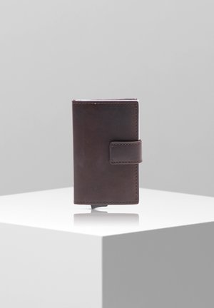 Brown leather wallet with a smooth texture, rectangular shape, and a side tab closure. Compact design with visible stitching details.