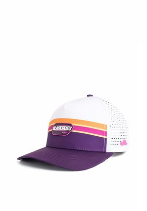 Man with short stubble wearing a white shirt and a white, purple, orange, and pink "BLACKSKIES PRO" cap, looking straight ahead.