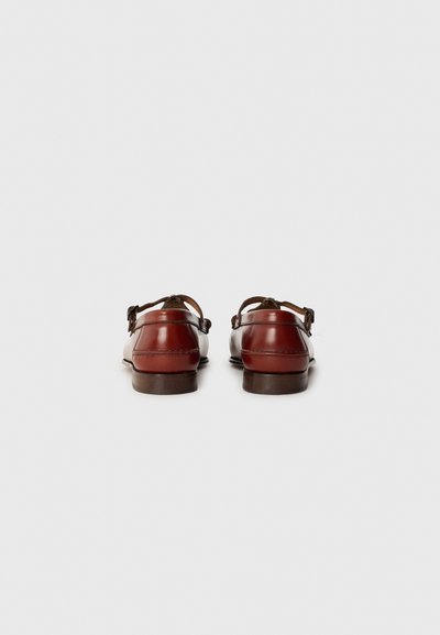 Brown leather shoes with back strap, smooth texture, rounded shape, low profile, and contrast stitching along the edges.