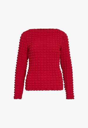 Suéter rojo texturizado con un diseño ancho, mangas largas y cuello redondo. La superficie presenta patrones cuadrados elevados para mayor dimensión.