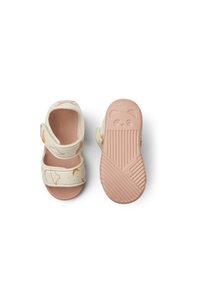 Light beige sandals with a textured pink sole, featuring whimsical cloud and moon patterns, two adjustable straps for a secure fit.