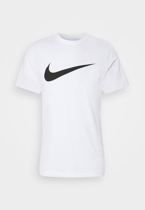 White cotton t-shirt featuring a prominent black Nike Swoosh logo across the chest. Short sleeves and a round neckline.