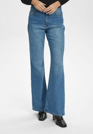 Blue high-waisted flared jeans in denim, featuring a classic five-pocket design, light fading, and contrast stitching.