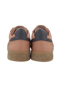 Pink suede sneakers with a navy leather accent and textured tan rubber sole, featuring rounded heel and minimal branding.