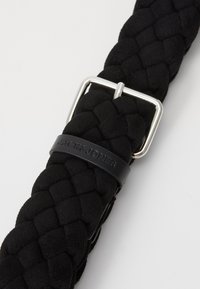 Black braided belt made of smooth fabric featuring a silver metal buckle and a black strap with the embossed brand name "JACK&JONES."