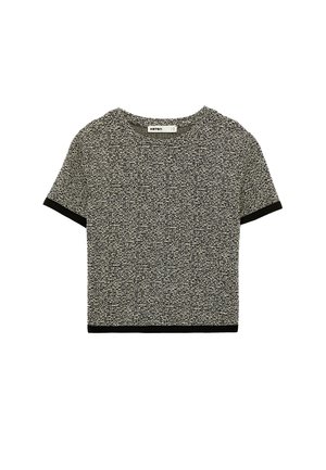 Kurzärmeliges Strick-Crop-Top mit schwarz-weißem Strukturmuster und schwarzem Besatz an Ärmeln und Saum.