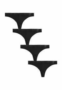 Svarta bomullstringtrosor staplade. Var och en har ett tunt midjeband med en flikig kant och präglat varumärke. Slät textur.