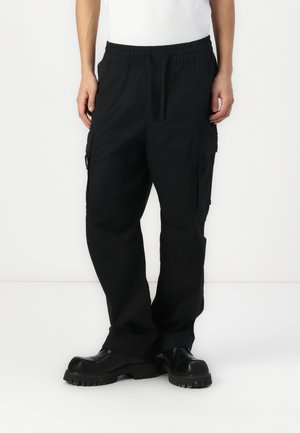 Black cargo pants with an elastic waistband, side pockets, and a relaxed fit. The fabric has a smooth texture and durable design.