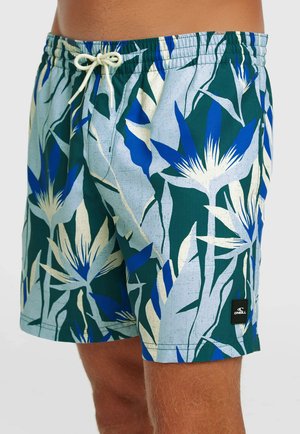 Pánske plavkové šortky s modrým, zeleným a bielym tropickým vzorom listov a kvetov, elastickým pásom a bielym zaväzovacím šnúrkou.