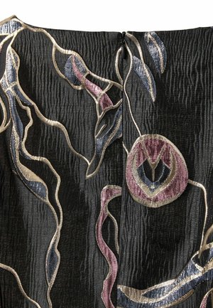 Close-up of textured black fabric with abstract floral embroidery in metallic gold, blue, and purple tones, featuring a centered black zipper.