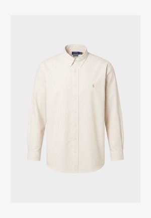 Šviesiai rudos ir baltos spalvos vertikaliai dryžuota ilgomis rankovėmis marškiniai su apykakle ir mažu siuvinėtu logotipu kairėje krūtinės pusėje.