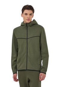 Giacca a vento verde oliva con cappuccio, cerniera frontale, dettagli neri e tasche laterali. Realizzata in tessuto morbido e testurizzato. Design aderente.