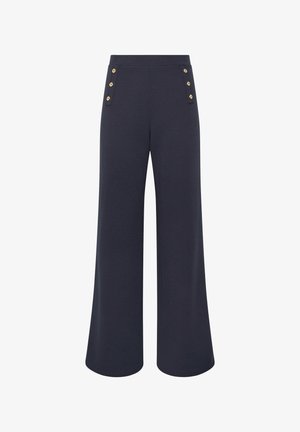 Laivastonsiniset leveälahkeiset housut, joissa on korkea vyötärö ja etutaskujen lähellä kaksi pystysuuntaista neljän kultaisen napin riviä.