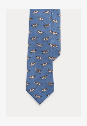 Gravata azul com padrão repetitivo de cães castanhos e brancos. Feita de tecido texturado com ponta apontada.