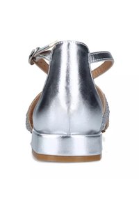 Sandali metallici argentati con tacco basso. Presentano una fascia posteriore e una parte superiore testurizzata, che mette in mostra una finitura liscia e un semplice dettaglio a fibbia.