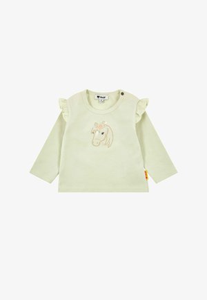 Camisa de manga larga verde pálido con detalles de volantes en los hombros y un diseño bordado de unicornio con flores. Dos broches a presión a los lados del cuello.