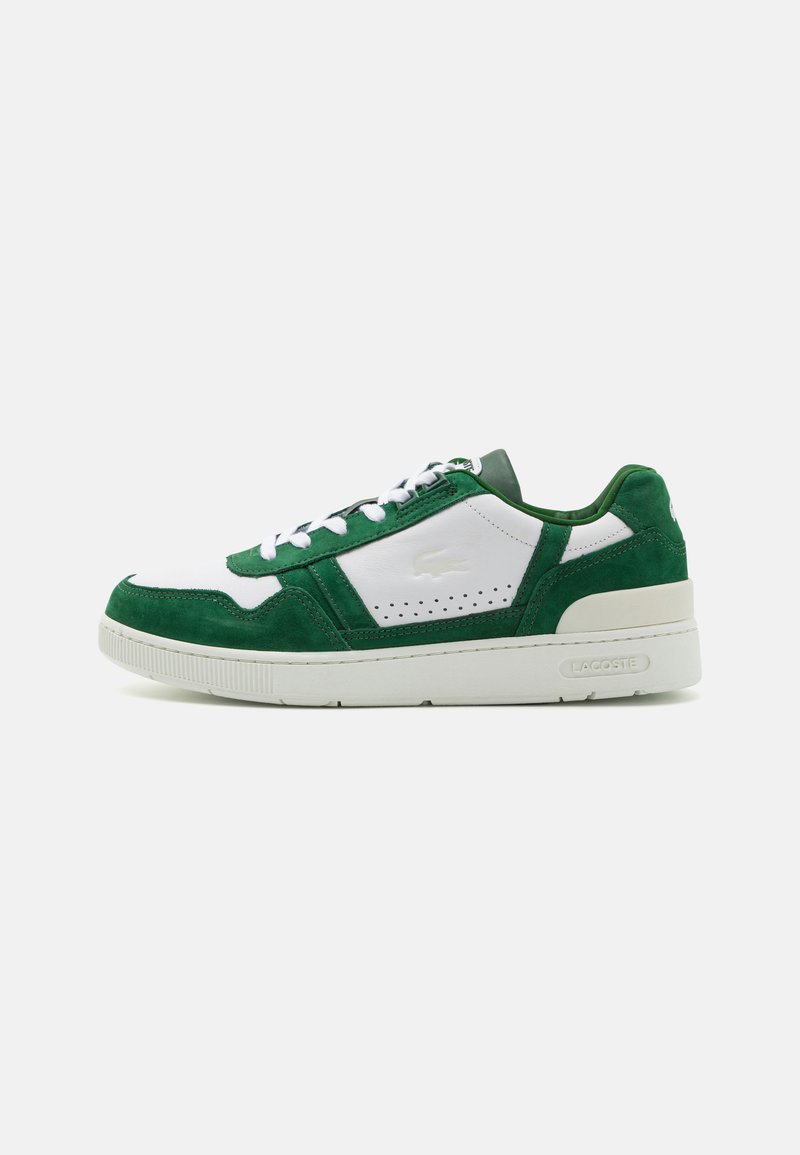 Green and white sneaker made of suede and leather, featuring a lace-up design, perforated accents, and a thick white sole.