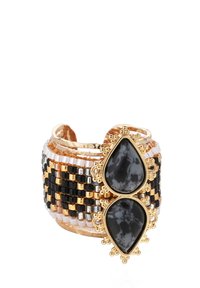 Bracelet à large poignet featuring des perles tressées noires, dorées et argentées, orné de deux pierres noires en forme de goutte dans des montures dorées ornées.