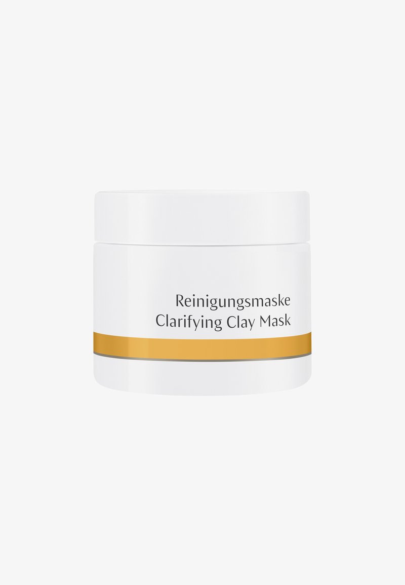 White cylindrical jar with a gold accent stripe and gray line. Label reads "Reinigungsmaske Clarifying Clay Mask" in black text.