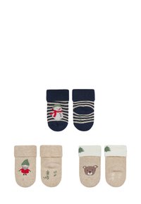 Set of four pairs of children's socks. Two are navy with striped design and snowman; two are beige with bear and tree patterns, varying textures.