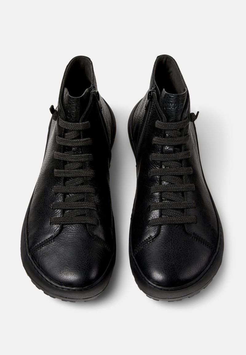 Pair of black leather high-top sneakers with textured surface, black laces, and side zippers, shown from above on white background.