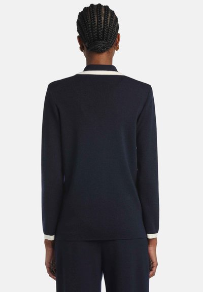 Navy long-sleeve sweater with a white collar trim and ribbed texture. Features a fitted design and a straight back silhouette.