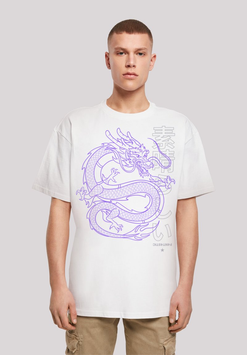 White oversized t-shirt featuring a purple dragon graphic and Asian text. The fabric appears soft, with a relaxed fit and short sleeves.