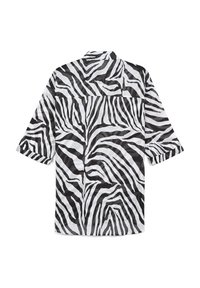 Camicia a strisce zebrate in bianco e nero con colletto a camicia, maniche lunghe e vestibilità comoda; realizzata in tessuto leggero.