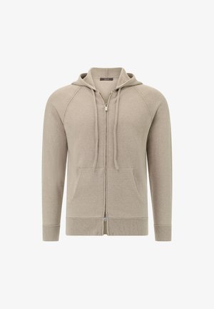 Lys beige strikket hættejakke med fuld lynlås, frontlommer og justerbare snore. Har ribbede manchetter og kant for en tætsiddende pasform.