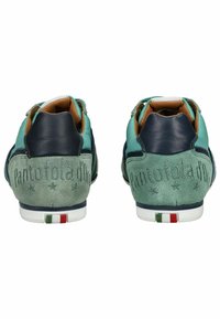 Green suede and navy leather sneakers featuring embossed logo, contrasting accents, and tri-color heel detail. Low-top design with fabric lining.
