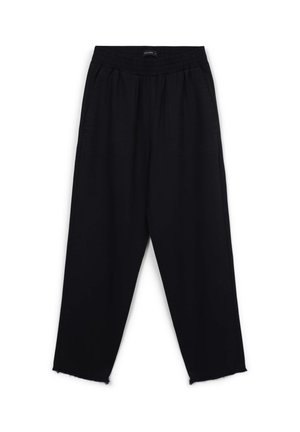 Pantaloni neri dal taglio morbido con vita elastica, tasche laterali e orli leggermente sfilacciati, presentati su uno sfondo bianco.