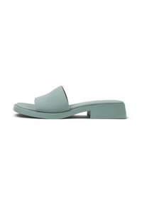 Mint green slide sandal with a wide, smooth strap and a low block heel. Made of a soft material, featuring a minimalist design.