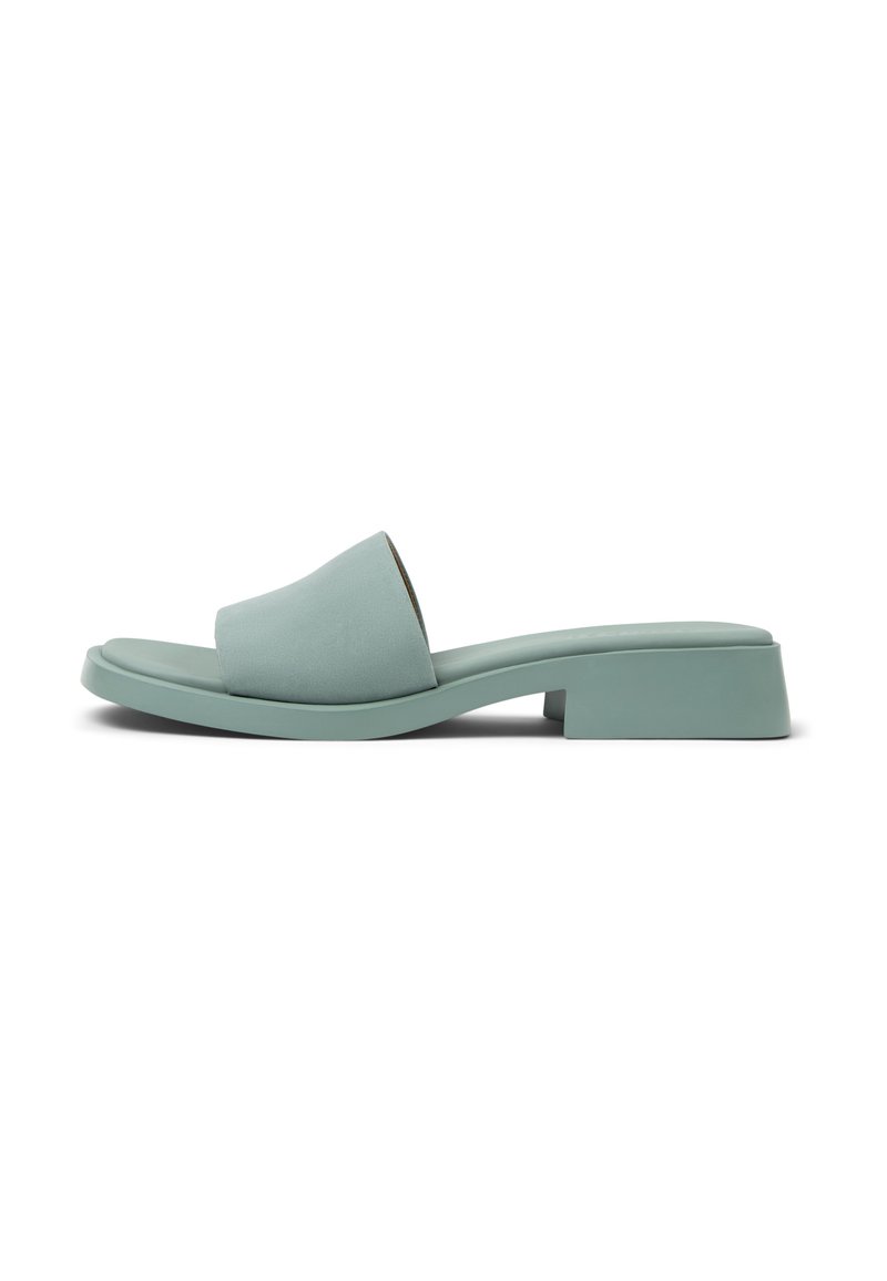 Mint green slide sandal with a wide, smooth strap and a low block heel. Made of a soft material, featuring a minimalist design.