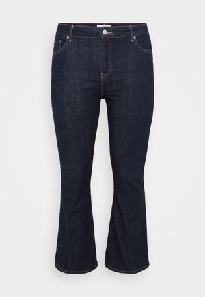 Tumed sinine teksariie, flared disainiga, klassikalise viiega tasku ja metallist nööbiga kinnitamine, kontrastõmblustega õmblustes.