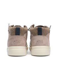 Bottines en daim beige avec un col en laine tan, logo embossé "WALK IN PITAS", et une semelle en caoutchouc léger, présentant une boucle en tissu bleu à l'arrière.