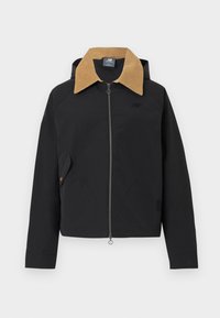 Veste noire à fermeture éclair avec col en velours côtelé beige, poche latérale avec rabat et logo discret sur la poitrine, affichée à plat sur un fond blanc.