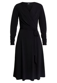 Svart omslagsklänning med långa ärmar, V-ringning och knytning i midjan. Mjuk, figurnära tyg med en flödande kjol som når till mitten av vadbenet.