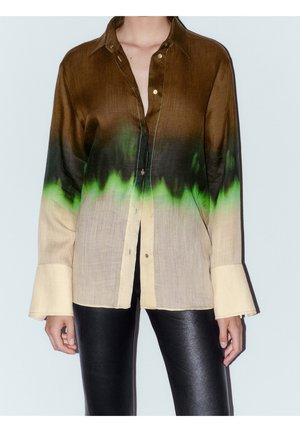 Long-sleeve button-up shirt with brown, black, green, and beige gradient worn with black leather pants.