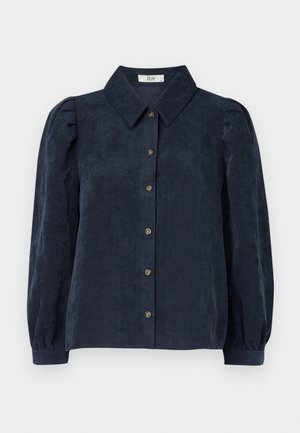 Donkerblauwe corduroy shirt met een kraag, voorkant met knopen en opgeblazen mouwen. Heeft een verticale ribbelstructuur.