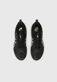 Black athletic shoes with a textured upper, flat laces, and white accent stripes. Features a rounded toe and cushioned white sole.