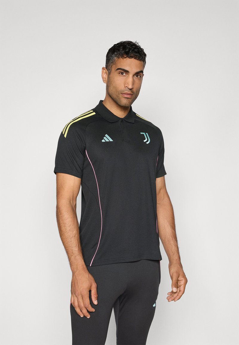 Black polo shirt with yellow shoulder stripes, pink accents, and adidas and Juventus logos. Made from moisture-wicking material.