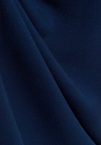 Navy blue fabric with a smooth texture, showcasing subtle folds and a uniform appearance, made from a lightweight material.