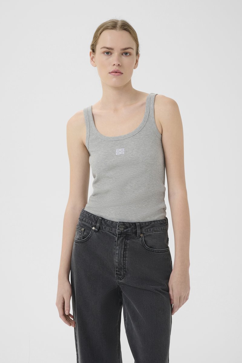 Gray ribbed tank top with a scoop neck and white logo detail. Paired with high-waisted black denim jeans featuring front pockets.